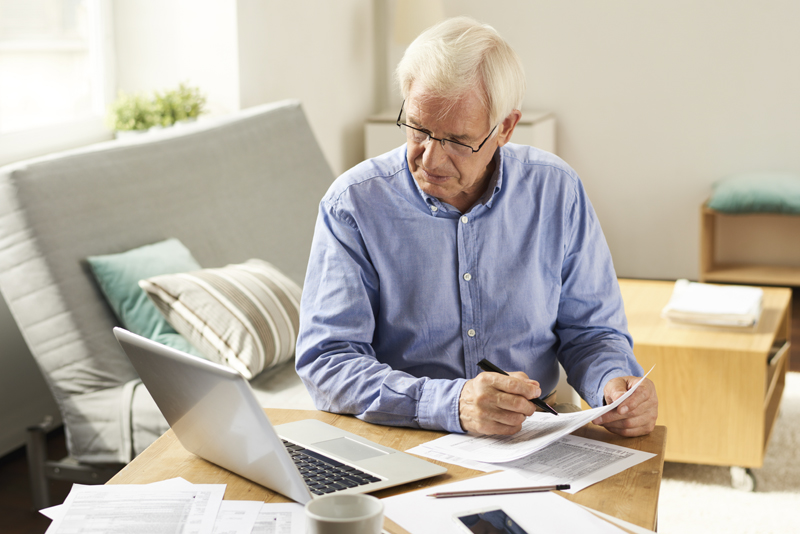 elderly man reviewing taxes