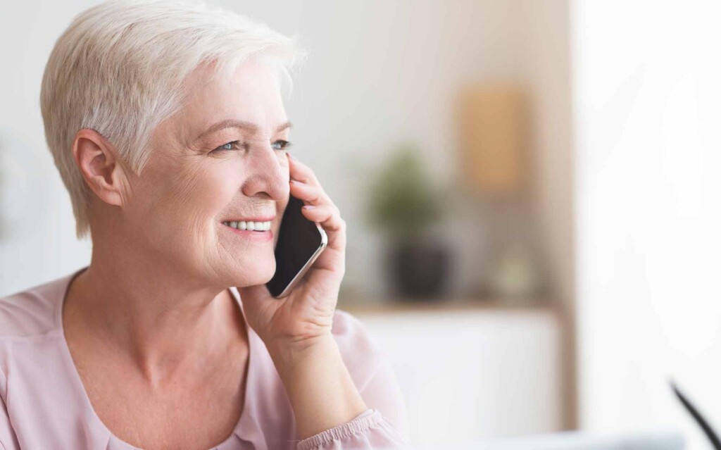 close up of mature business woman talking by phone